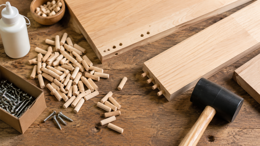 Woodworking workbench with wooden dowel pins, screws, a drilled joint, and wood glue